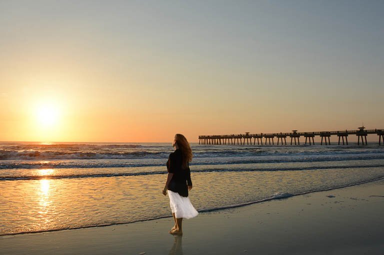 Woman standing on Florida beach at sunrise