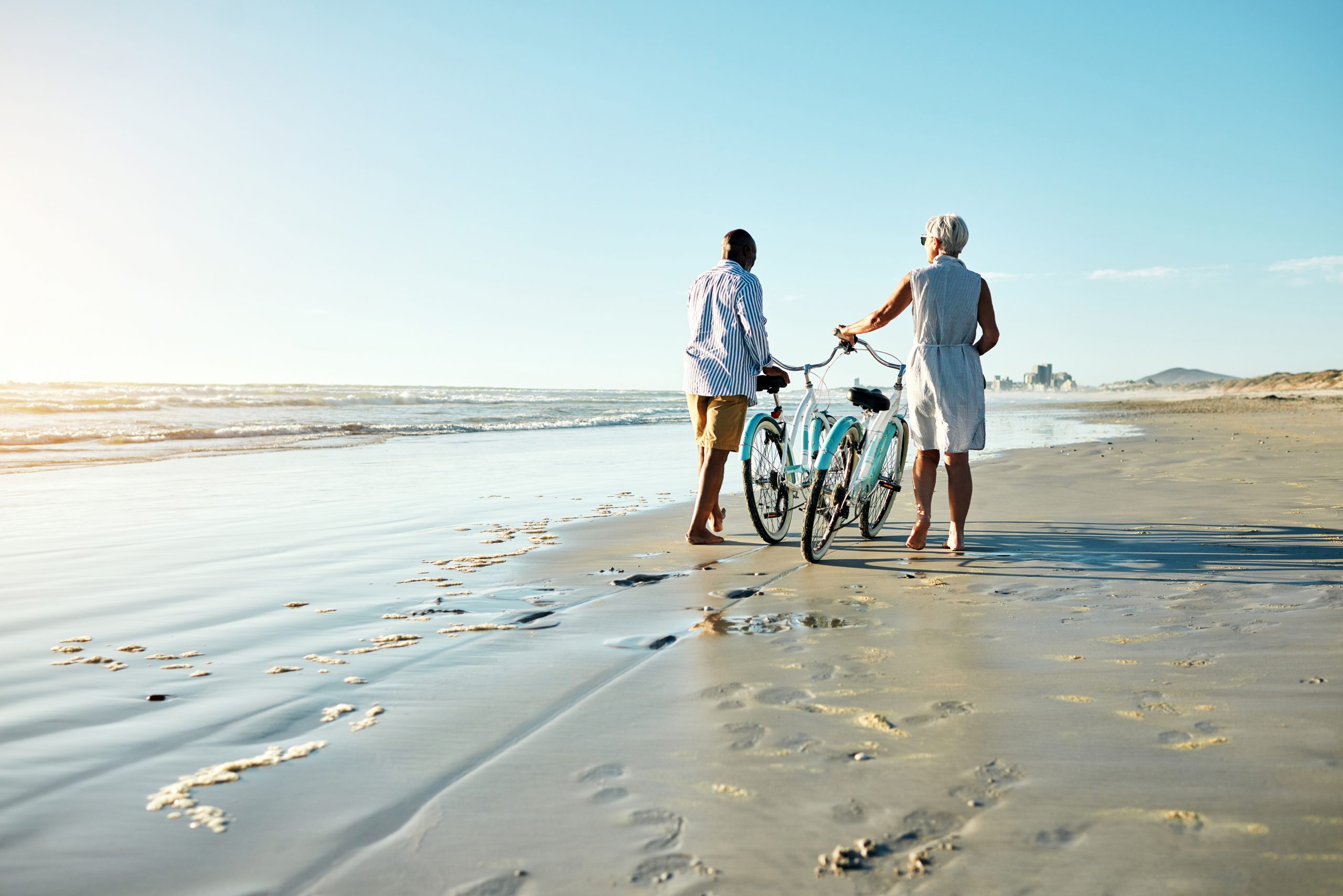 Senior Couple on beach riding bikes